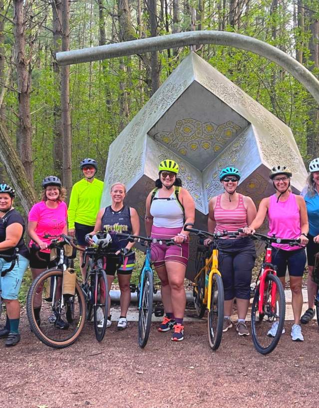 Female centered biking group, Girls on Gravel, biking at the Stevens Point Sculpture Park.