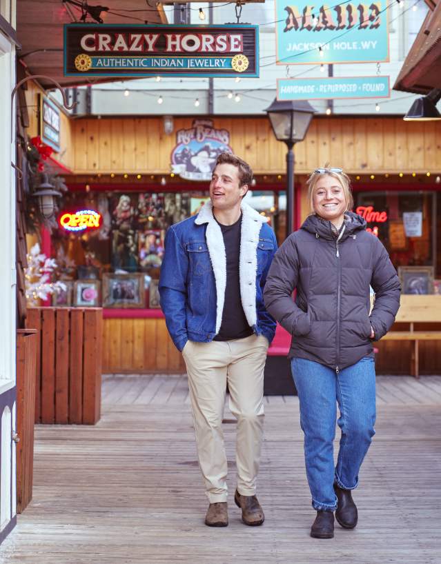 two people strolling along window shops