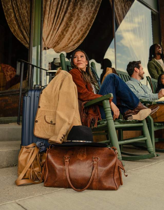 Friends exploring local boutiques and shops on a lively downtown Wyoming main street, framed by classic Western architecture.