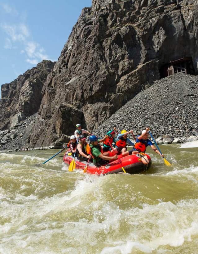 Group of people rafting through whitewater rapids on a river in Fremont County, near Thermopolis, Wyoming.
