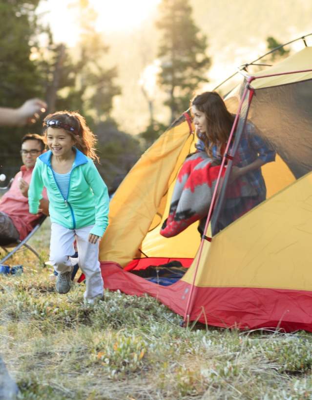 Family at campsite with tent.