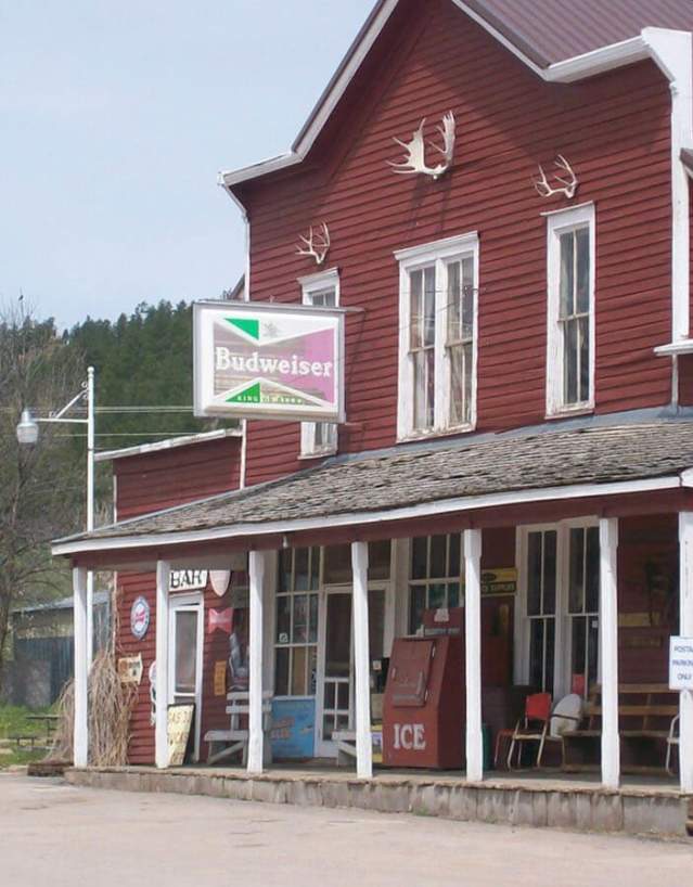 Historic Aladdin General Store and gas station with vintage signage in Crook County, Wyoming.