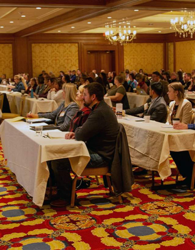 Conference attendees listening to a presentor