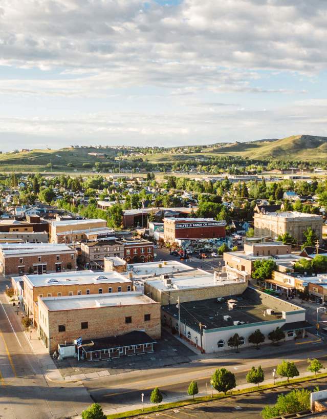 An aerial overlooking view of a small town in Wyoming with streets and buildings.