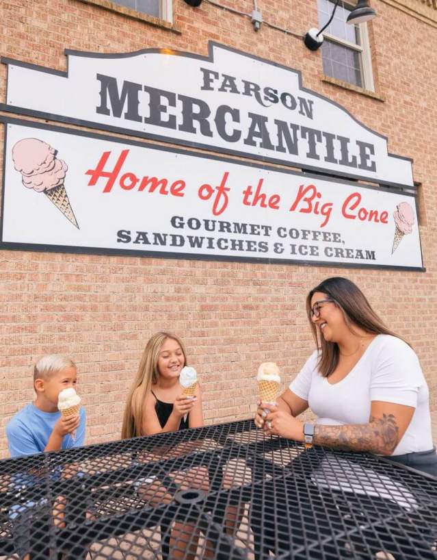 Exterior building of Farson Mercantile with family enjoying ice cream at picnic tables.