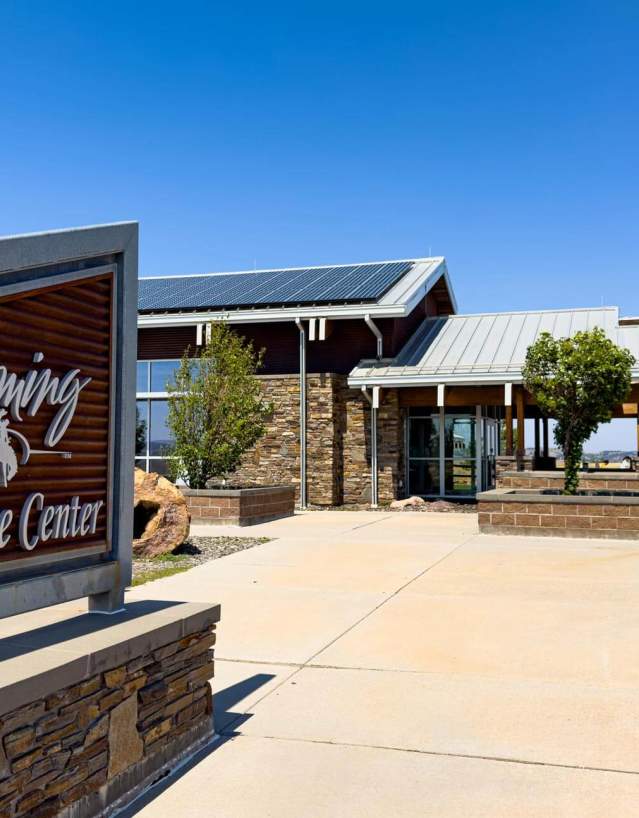A Wyoming welcome center with a sign out front.