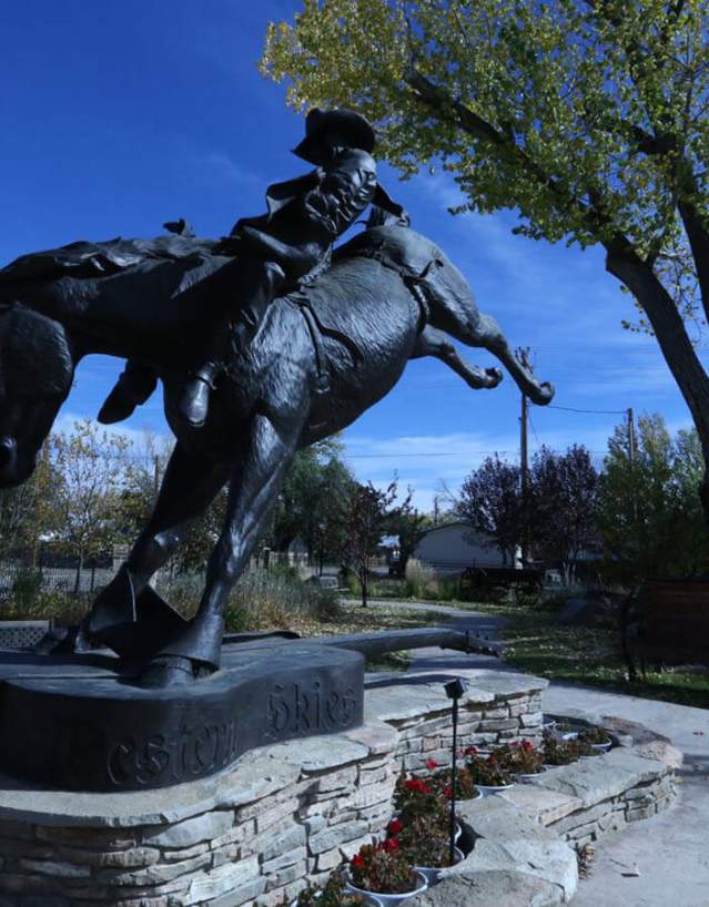 Bronze statue of Chris LeDoux riding a horse in Kaycee, Johnson County, Wyoming.