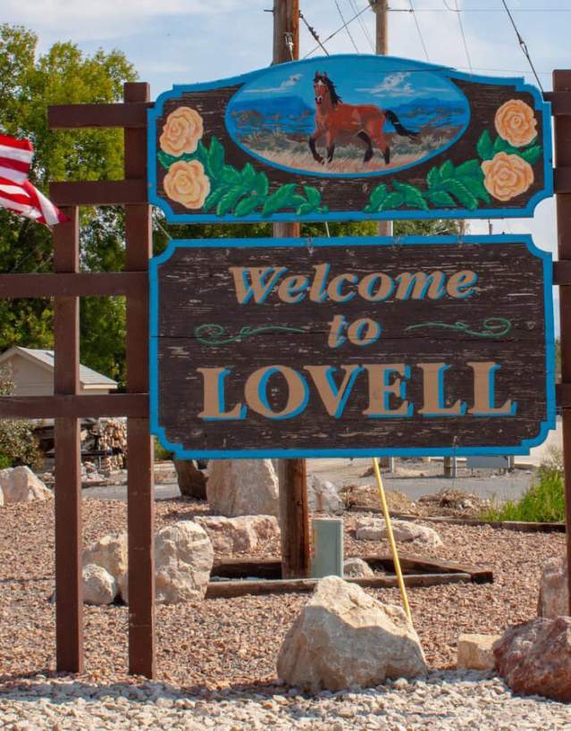 Welcome sign for Lovell, Wyoming, surrounded by scenery in Big Horn County.