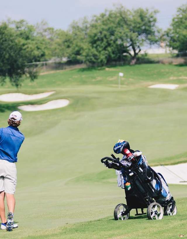 Man hitting a golf ball on a golf course