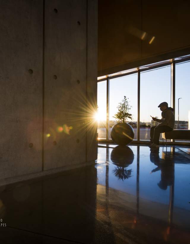 Convention Center Visitor in Lobby at Sunrise