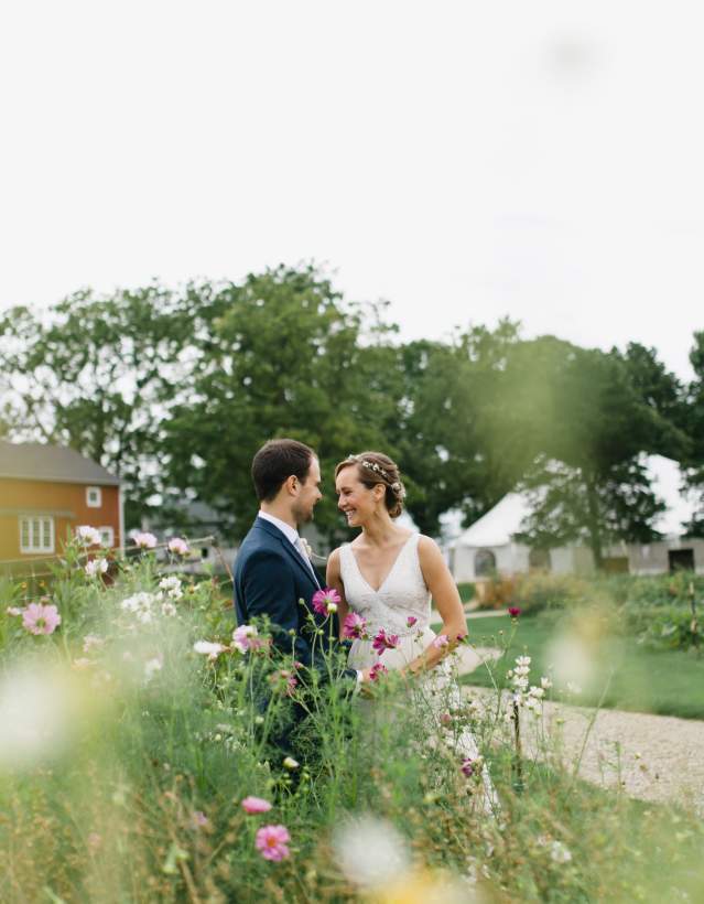 Bride and groom in field at Cornman Farms