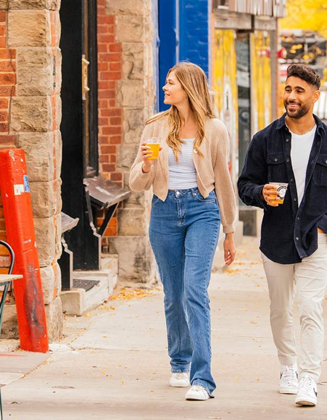 Couple walking down sidewalk in downtown Ann Arbor