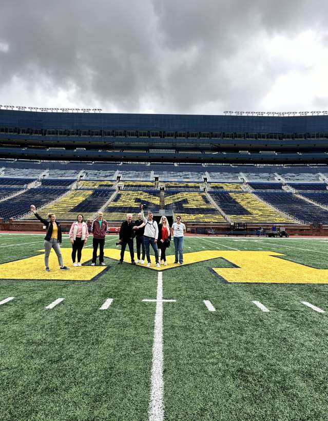 Group of people on field at Michigan Stadium