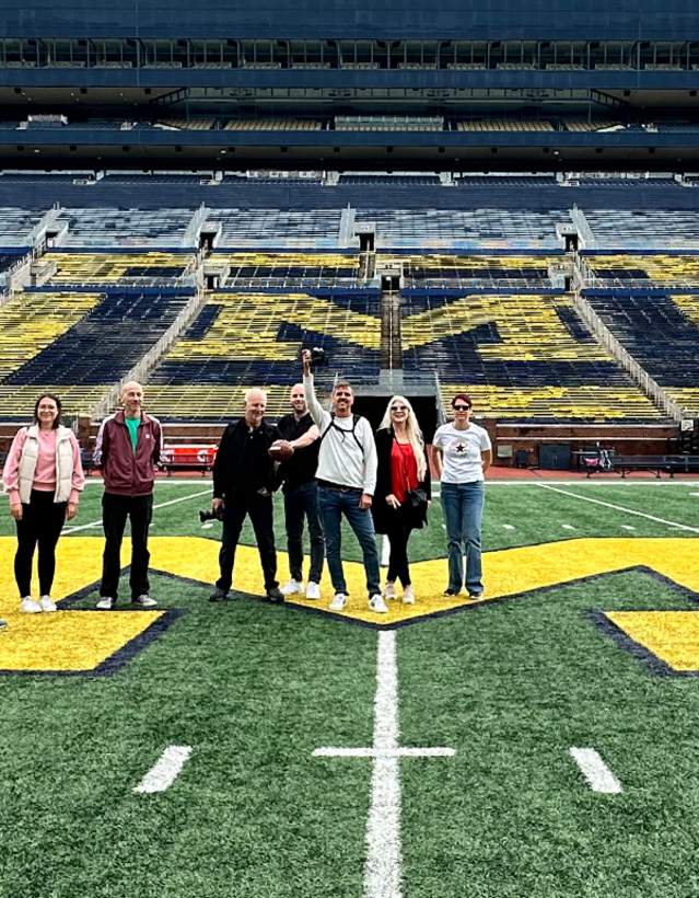 Tour group standing on field of Michigan Stadium