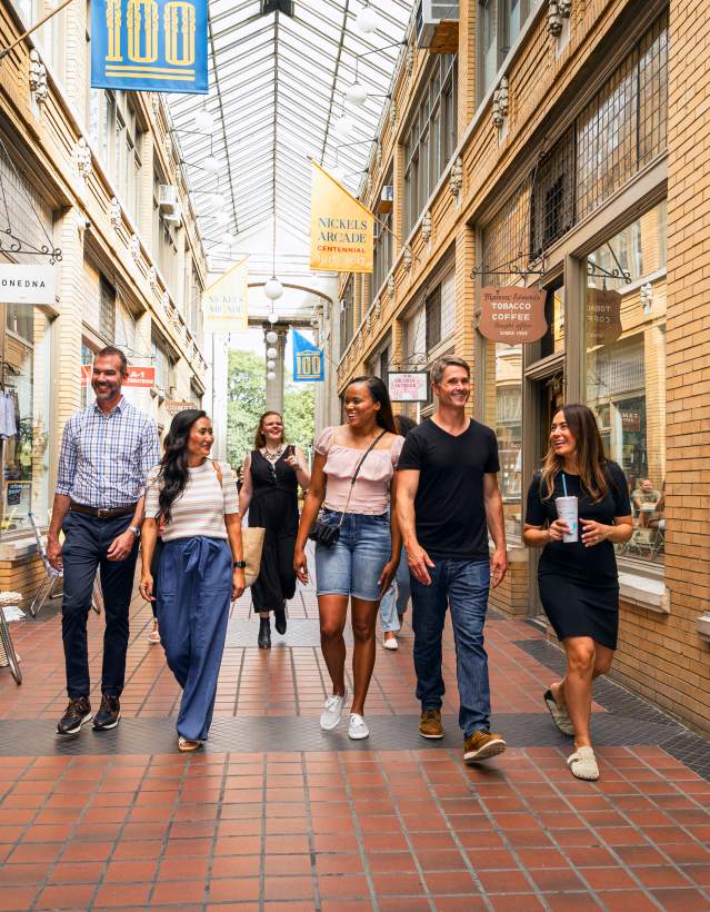 Group of professionals walking through Nickels Arcade