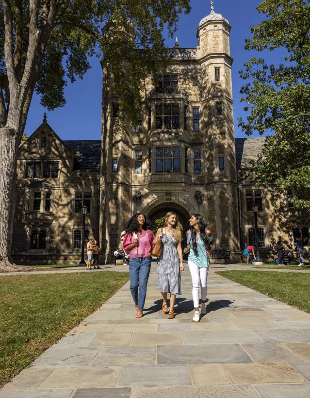 Three female students walking in U-M Law Quad