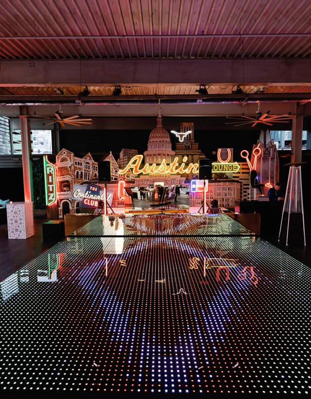 LED dance floor in front of an Austin-themed stage on the rooftop of Brazos Hall.