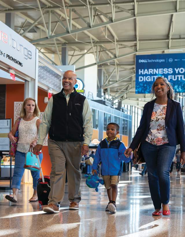 Family walking through the Austin Bergstrom Internation Airport Concourse