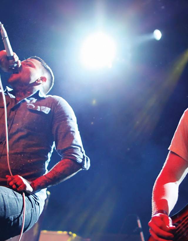 Live concert in East Austin with singer and bass player on stage