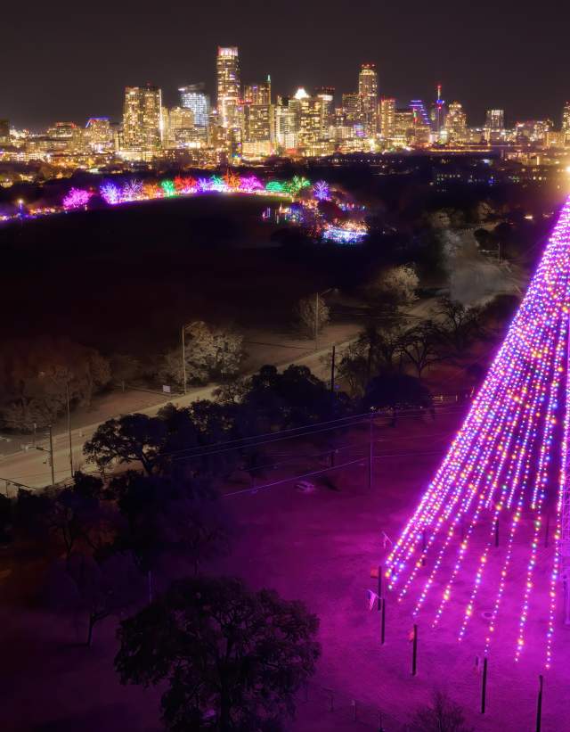 Image of Trail of Lights illuminated at night with the Downtown Austin skyline in the background.