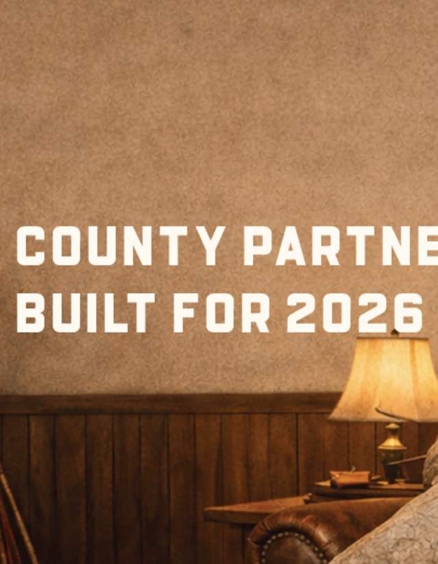 An image of a stone man with a name tag that says 'Cardi G', a play on the Cardiff Giant attraction in Cooperstown, with a fireplace and the words The Otsego County Partner Program built for 2026.