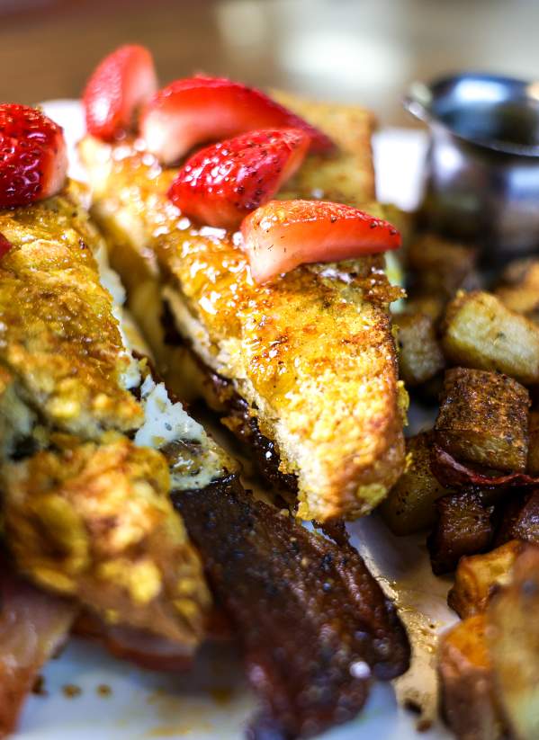 French Toast with eggs, candied bacon, ham and breakfast potatoes.