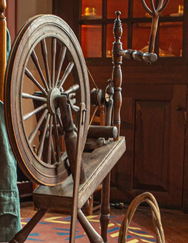 Rustic Interior With Cabinets, Chairs And Spinning Wheel At Stephen Hopkins House