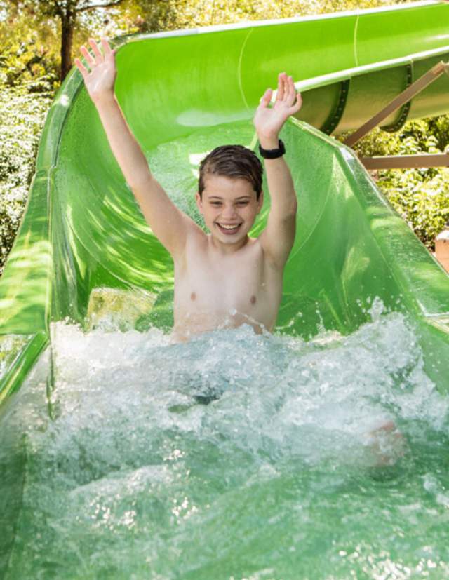 Child splashing down waterslide