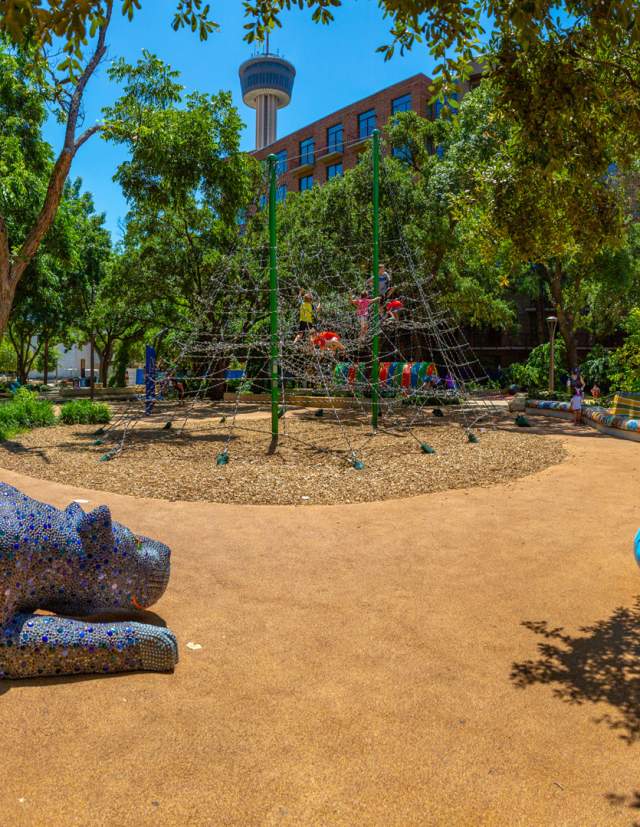 Outdoor play area with Tower of the Americas in the background