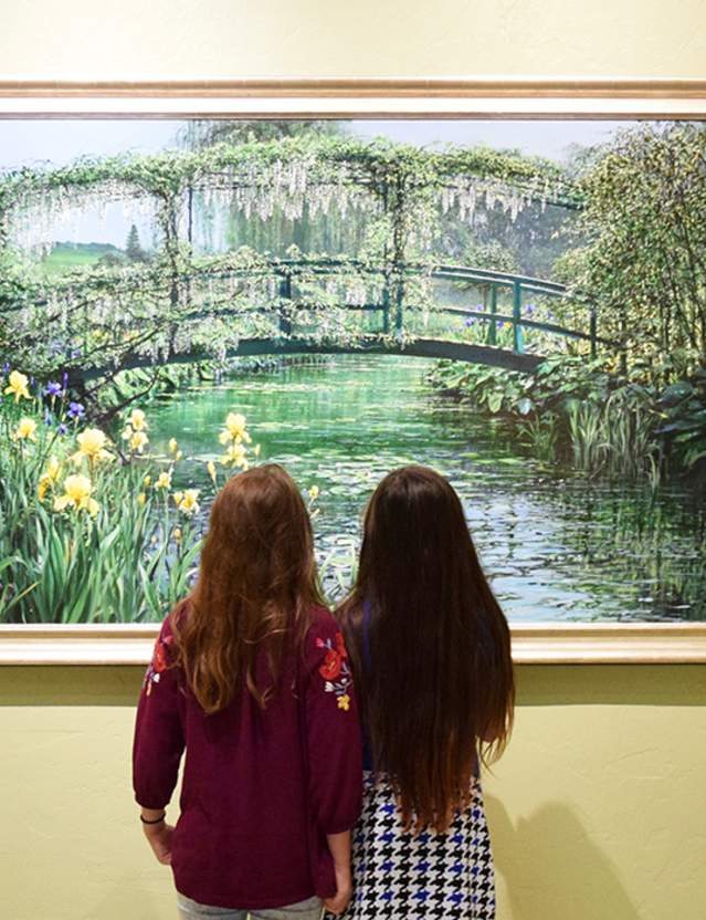 Two girls looking at a painting at R.W. Norton Art Gallery