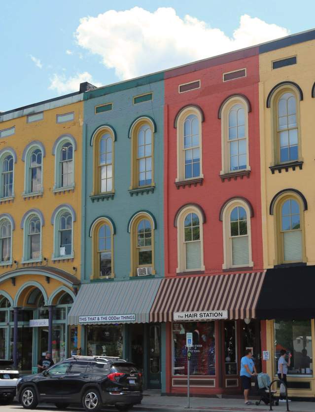 People walking by colorful buildings in Depot Town in Ypsilnati