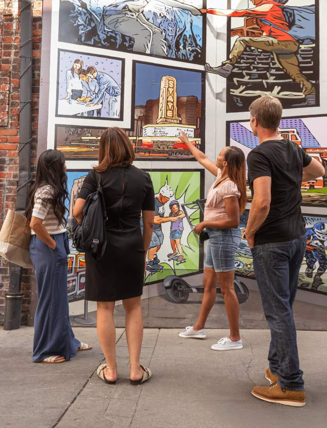 Group of professional looking at downtwon mural