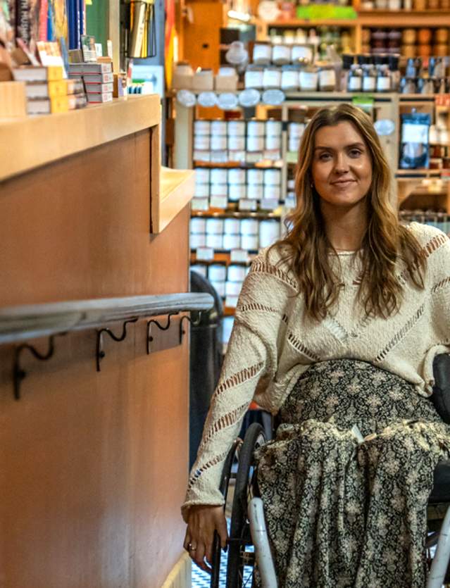 Female wheelchair user going up ramp at Zingerman's