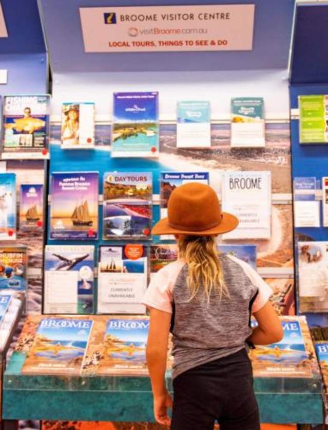 Child browsing the brochure racks at Broome Visitor Centre