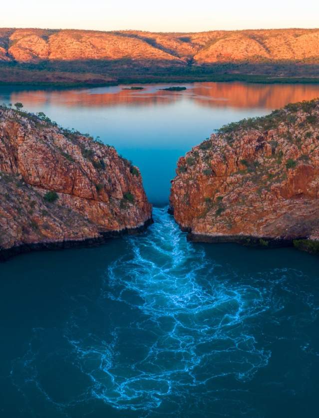 A drone image showing water flowing through the wide gap of Garaanngaddim Horizontal Falls on the Kimberley Coast