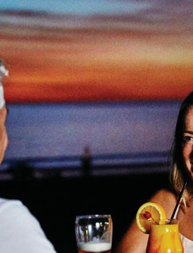 Couple at Cable Beach enjoying sunset drinks - TWA