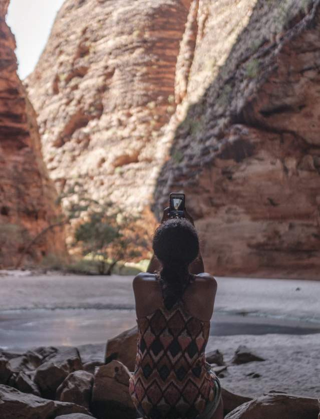 A visitor taking a photo in Cathedral Gorge, Purnululu National Park