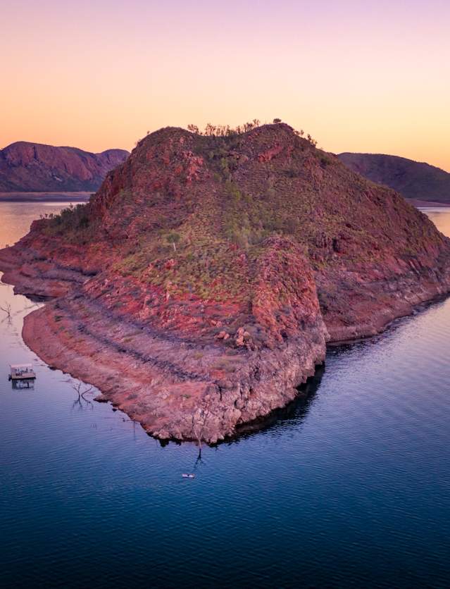 View of an island in Lake Argyle with a boat moored alongside.