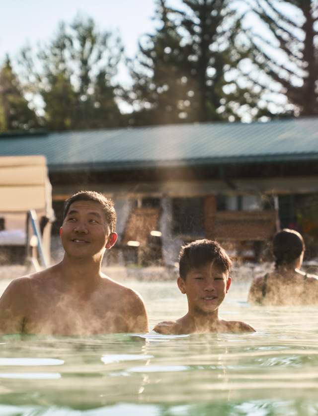 people soaking in warm water of hotsprings at a hotel