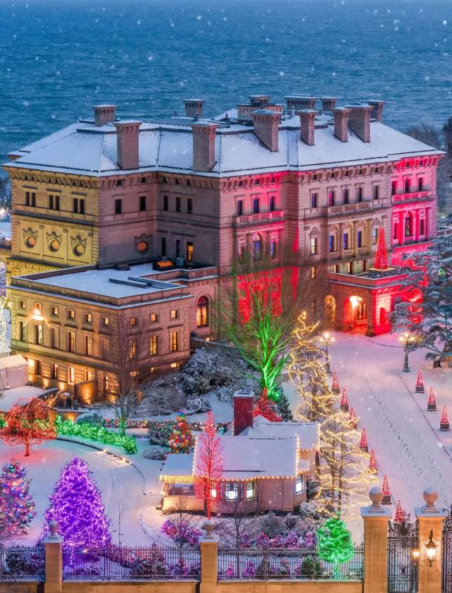 A large building with colorful lights in a snowy landscape.