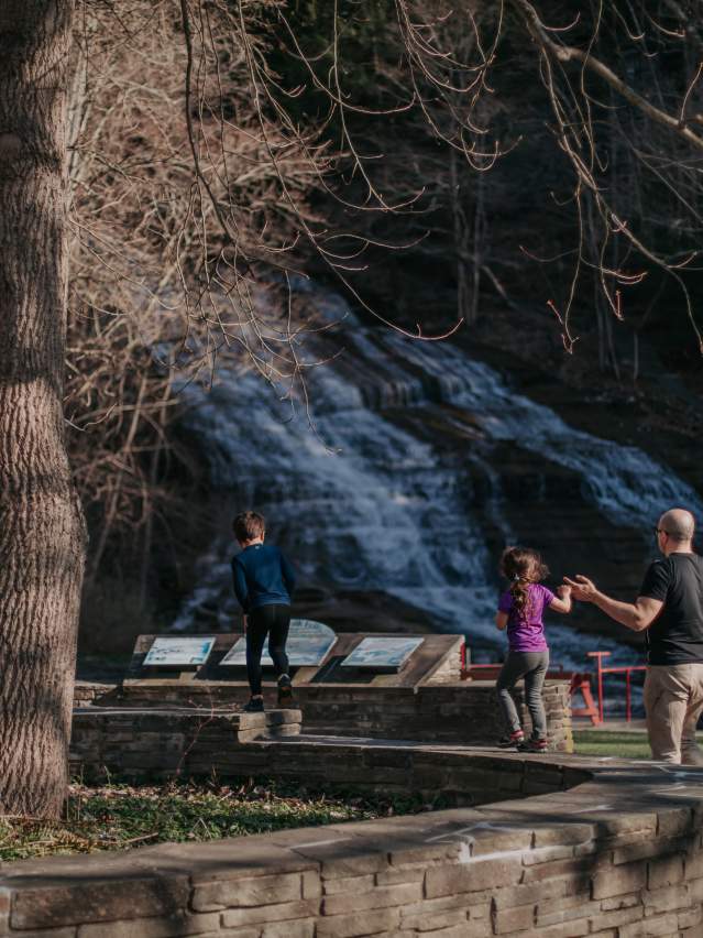 family at Buttermilk Falls Park in spring