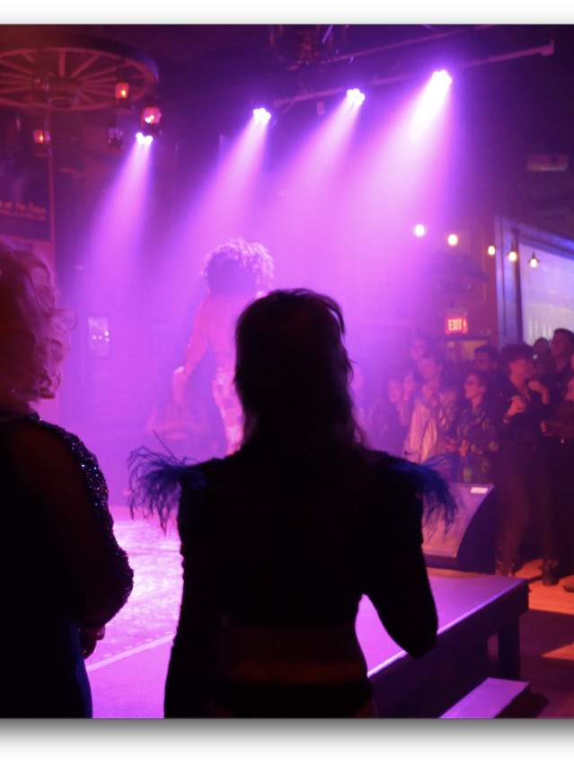 dark stage with drag performers