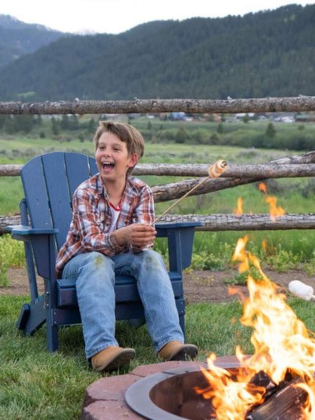 Family enjoying smores around a campfire