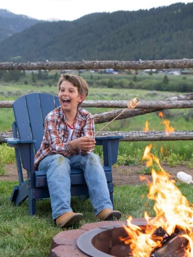 Family enjoying smores around a campfire