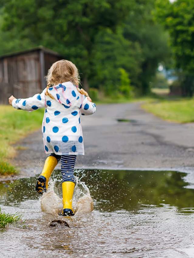 Girl splashing in the rain