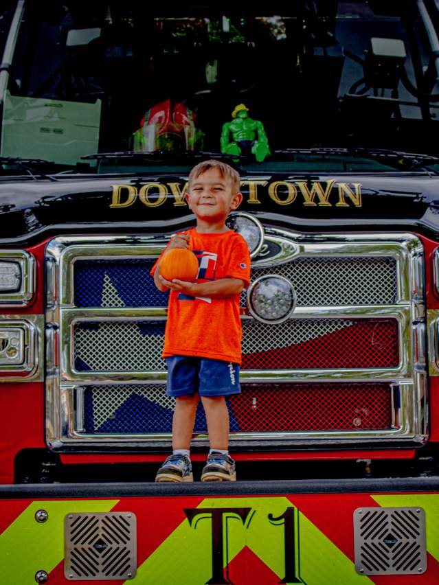 Kid with pumpkin on Firetruck