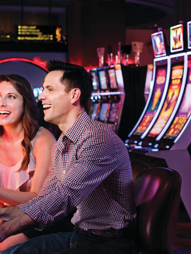 A couple plays the slots at the Choctaw Casino.