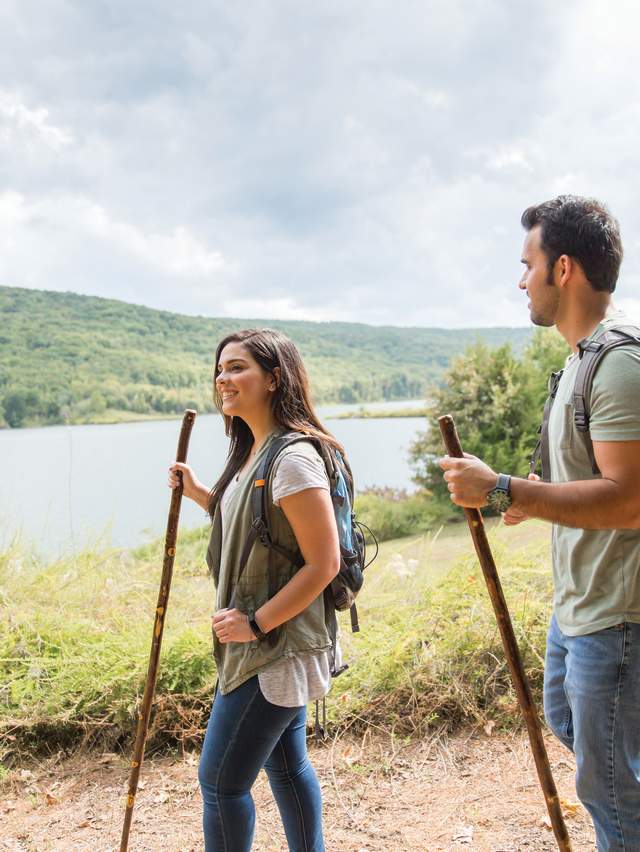 A couple hikes a train in Lake Fort Smith State Park.