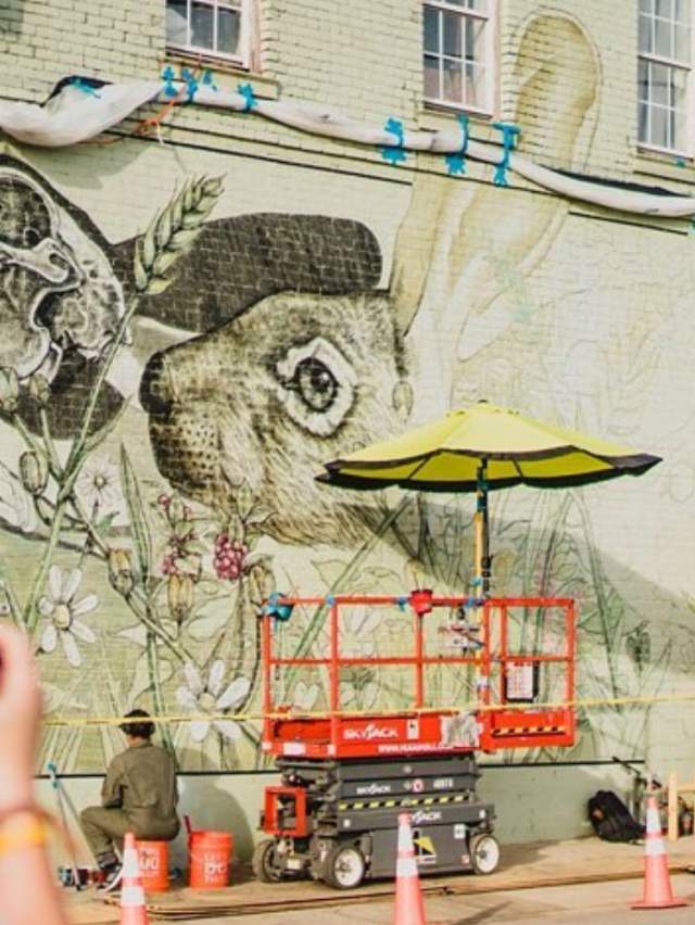 Artist working on mural