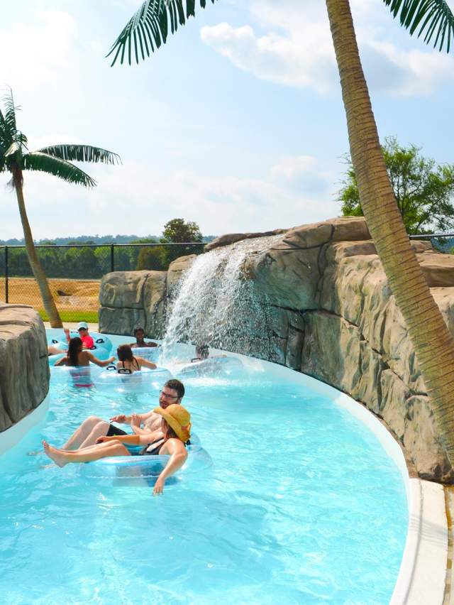 Children and adults float down a cool, blue lazy river at Parrot Island Water Park in Fort Smith.